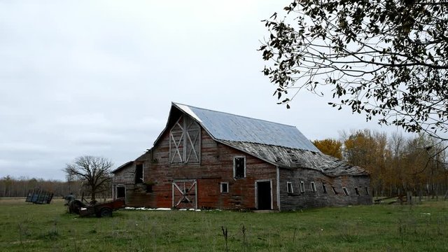 Abandoned lonely dilapidated Farm Barn in northern Minnesota on dreary cloudy day