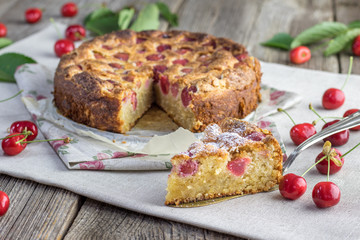 Piece of Czech rounded black cherries bubble cake or souffle on table.