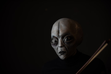 Alien enjoying playing violin  