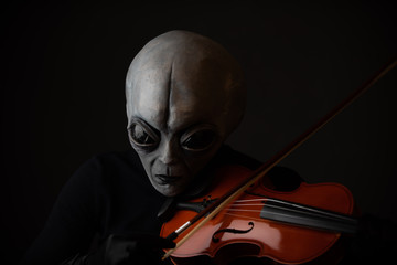 Alien enjoying playing violin  