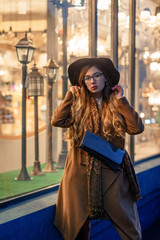 beautiful girl on a city street in the evening in the autumn