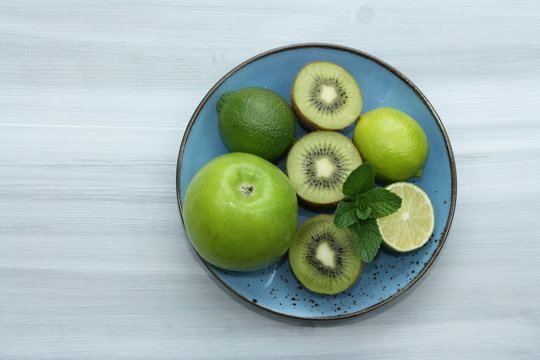 Fresh green fruits on grey background. Detox and diet concept.