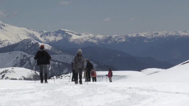 People walking in mountaing with snow