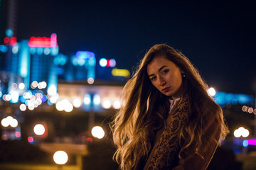 beautiful girl on a city street in the evening in the autumn