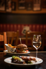 american hamburger with glass of beer of wine in american restaurant, product photography for restaurant in american style