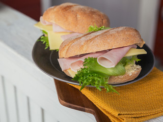 Ciabatta baguette sandwiches with ham, cheese and lettuce