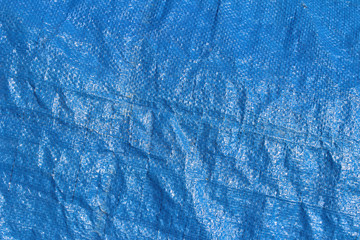 Blue wrinkled textured rough waterproof plastic cover surface horizontal detail 