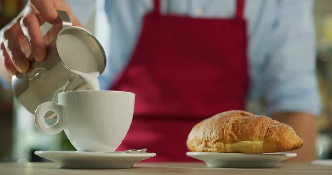 Tipi di file: Tutto (421) Vai a pagina |12345Avanti Portrait of a barman while making a coffee with cream and cocoa on the table of a bar. 
