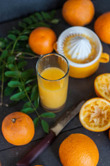 Oranges and juicer for making orange juice.. Black-gray background.