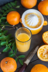 Oranges and juicer for making orange juice.. Black-gray background.
