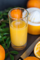 Oranges and juicer for making orange juice.. Black-gray background.