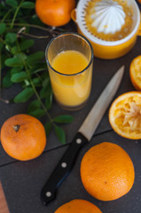 Oranges and juicer for making orange juice.. Black-gray background.