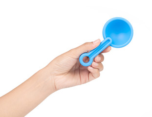 Hand holding Small plastic toy shovel isolated on a white background.