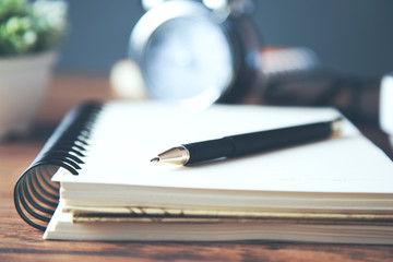 clock with stationery on table