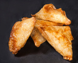 Indian samosas on black background