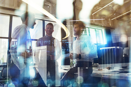 Business people work together in office. Concept of teamwork and partnership. double exposure with modern city and light effects