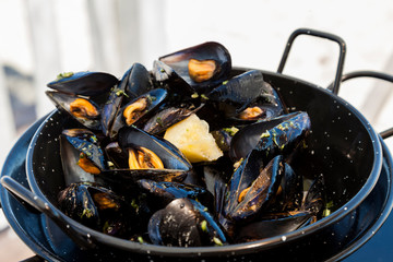 Traditional barbecue spanish  mussel in a black casserole