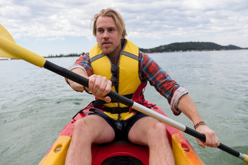 A man paddling his kayak around Ku-ring-gai Chase NP