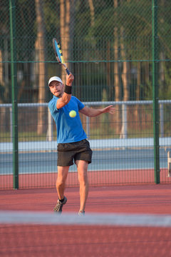 Caucasian man playing tennis on clay court