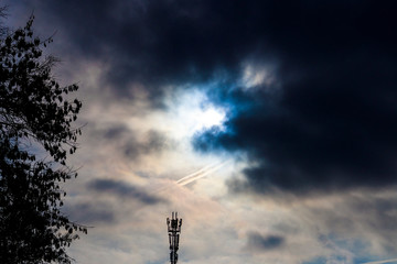 Obraz premium black sky. Telecommunication tower against a stormy cloudy sky