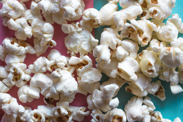 Popcorn cinema on pink pastel and blue pastel background. Movie snack