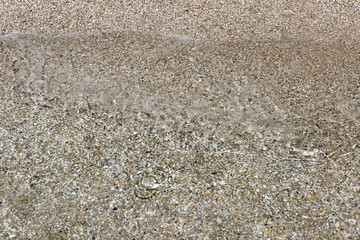 Shallow sea water beach sand pebbles sun