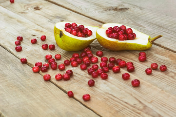Pear with berries on a wooden table
