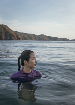 Portrait of a woman in a swimsuit  swimming in the sea.