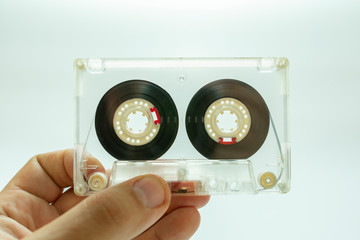 analog audio tape to listen to music in hand on white background