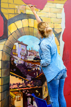 Young woman creating 3D painting outdoor