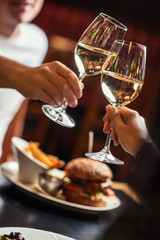 people eating and drinking in american restaurant, beer, hamburger, wine and other american specialites - obrazy, fototapety, plakaty