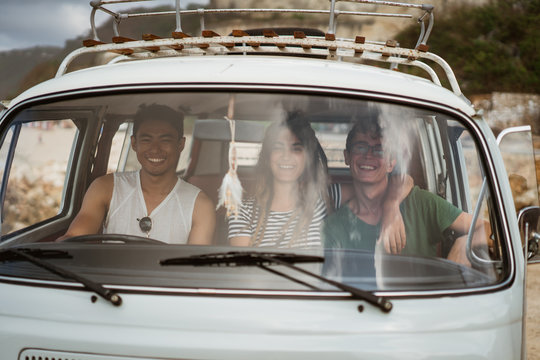 Hipster friends on road going to beach