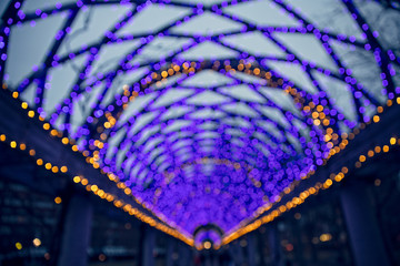 wooden arch decorated with Christmas lights. defocused. Arch of colored lights. Christmas...