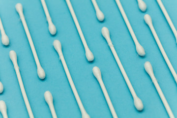 Cotton buds on a blue background. Sanitary qtip hygenic accessory. Plastic waste