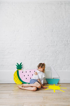 Girl Playing With Paper Crafts