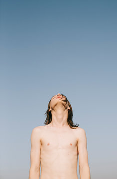 young androgyne on the blue sky background