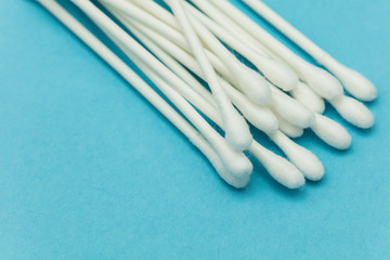 Cotton buds on a blue background. Sanitary qtip hygenic accessory. Plastic waste