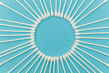 Cotton buds on a blue background. Sanitary qtip hygenic accessory. Plastic waste