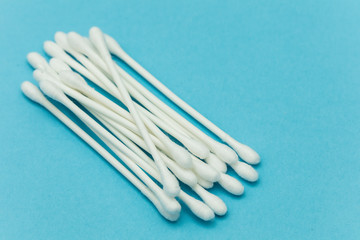 Cotton buds on a blue background. Sanitary qtip hygenic accessory. Plastic waste