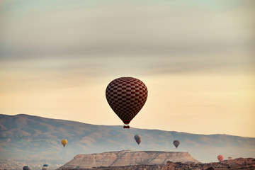Mountain landscape with large balloons in a short summer season at dawn.