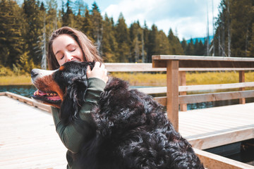 woman hugging a large dog 