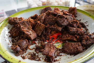 Spiced and fried chunks of beef meat on a plate