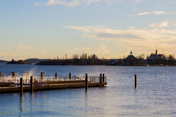 Obraz premium Finnish sauna with outside pool at the Harbour of Helsinki directly next to the ocean. The steam of the hot water is visible 