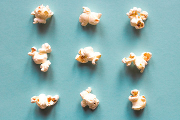 Popcorn on blue pastel background. Movie snack. Top view