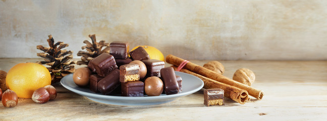 Chocolate cookies and sweets for Christmas and Advent on a rustic wooden table, panoramic format with copy space © Maren Winter