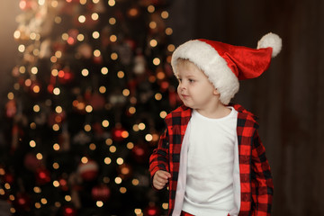 Christmas cute toddler  in Santa hat. Family holiday concept.