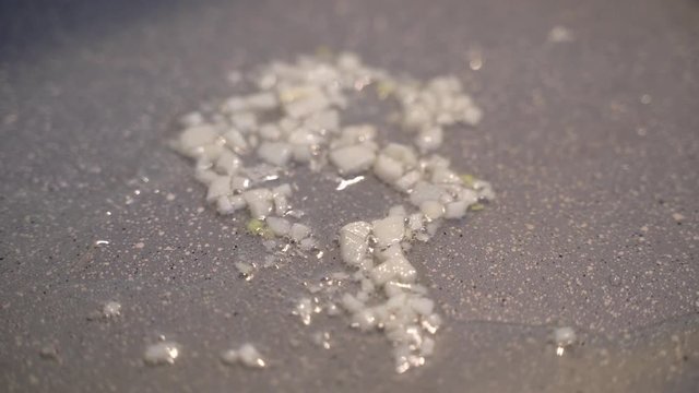 Frying Garlic On A Cooking Pan With Olive Oli