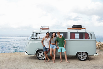 Portrait of friends standing together in beach