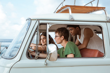 young people inside car using a map
