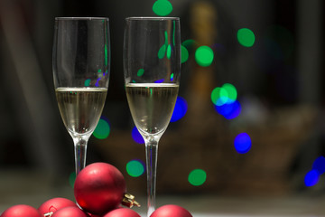 champagne glasses with balls and christmas lights